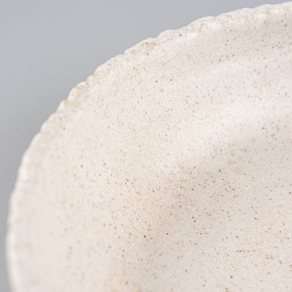 Corner angle showing matte glazed ceramic plate suitable for modern home and fine dining use.