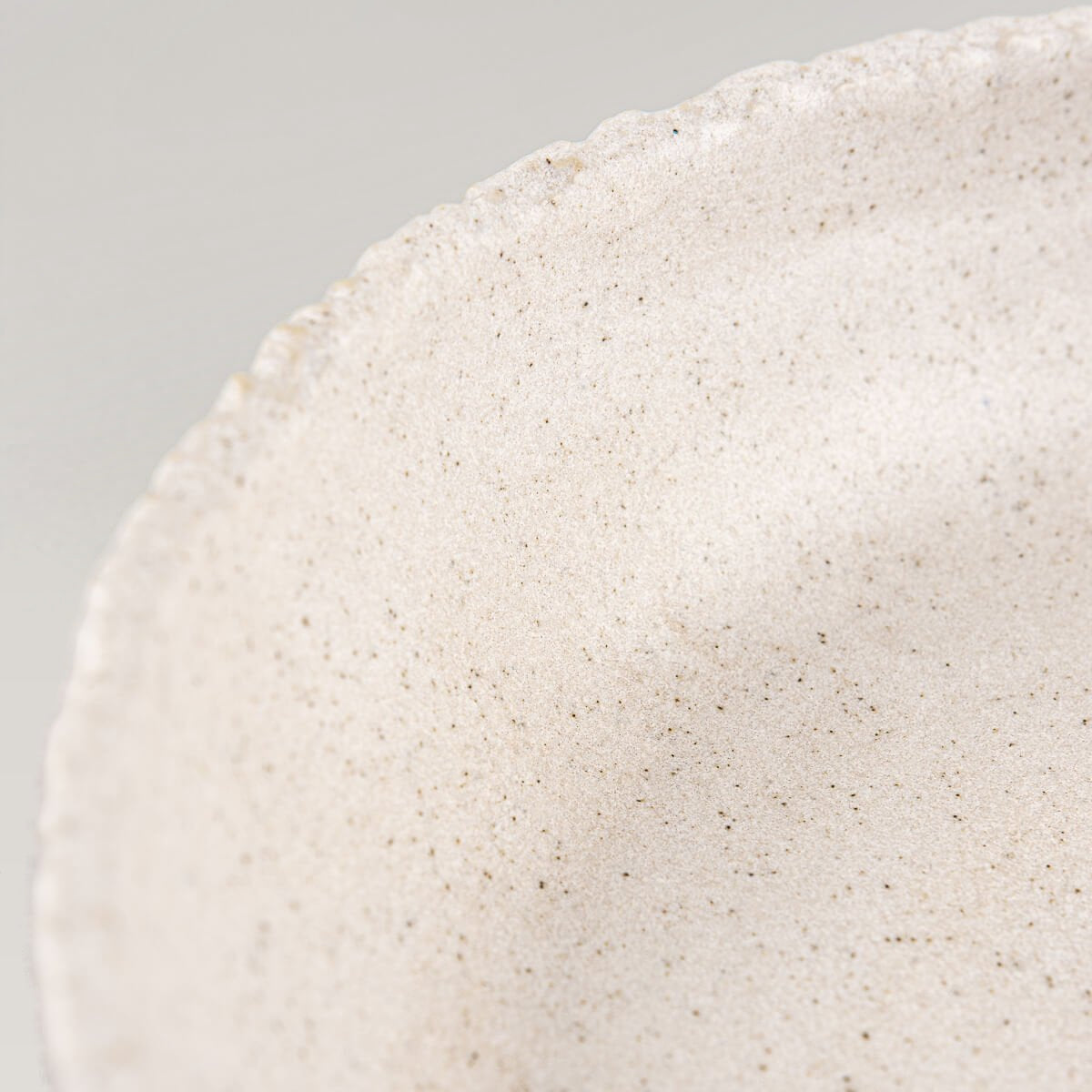 Corner angle showing matte glazed ceramic plate suitable for modern home and fine dining use.