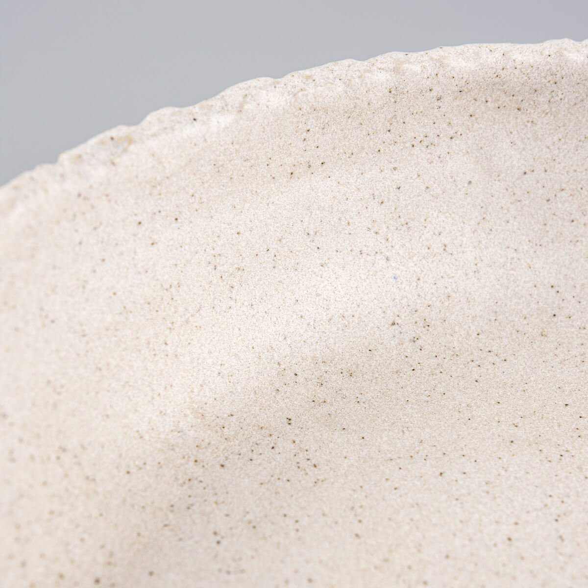Close-up of textured rim with raw edge finish, reflecting handmade pottery artistry.