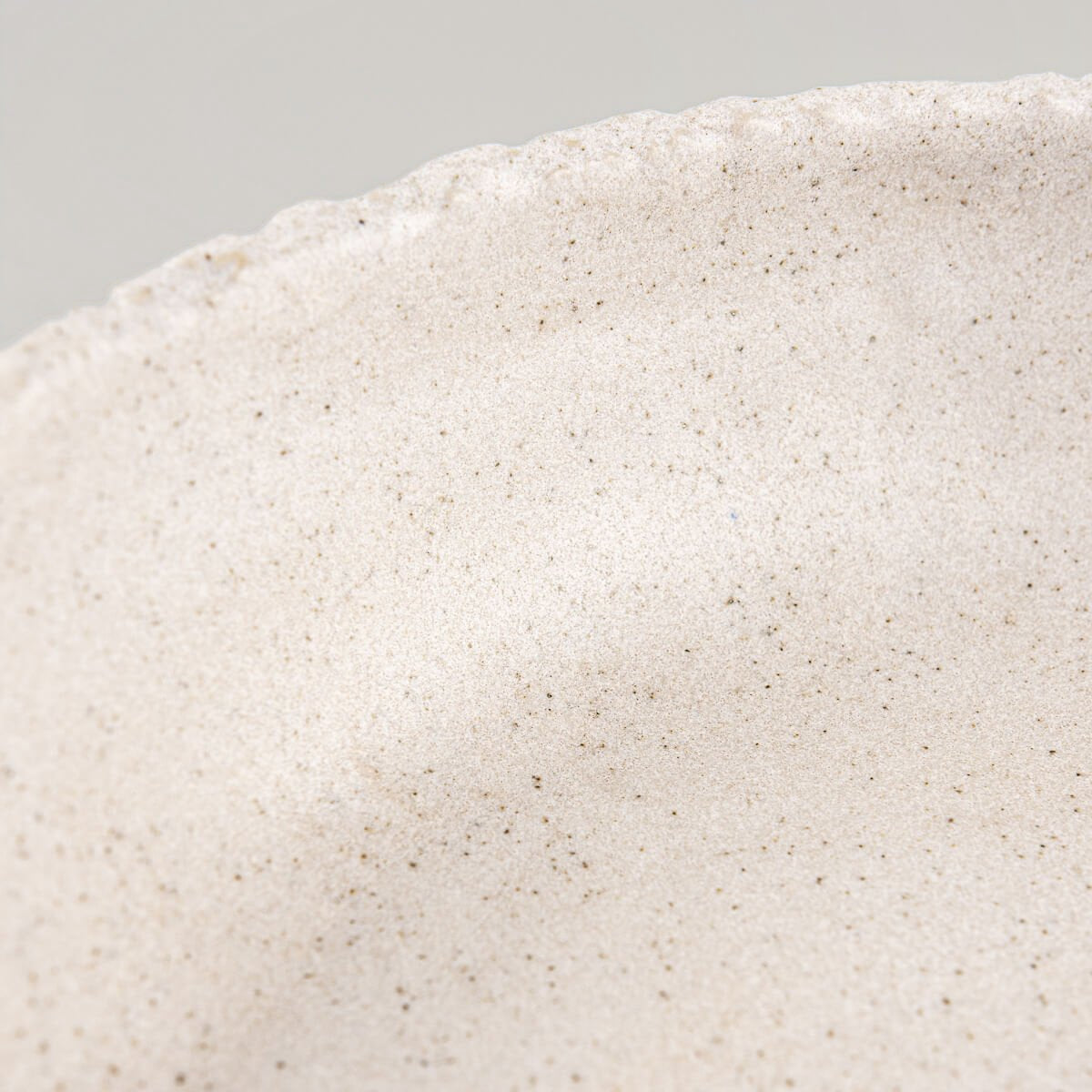 Close-up of textured rim with raw edge finish, reflecting handmade pottery artistry.
