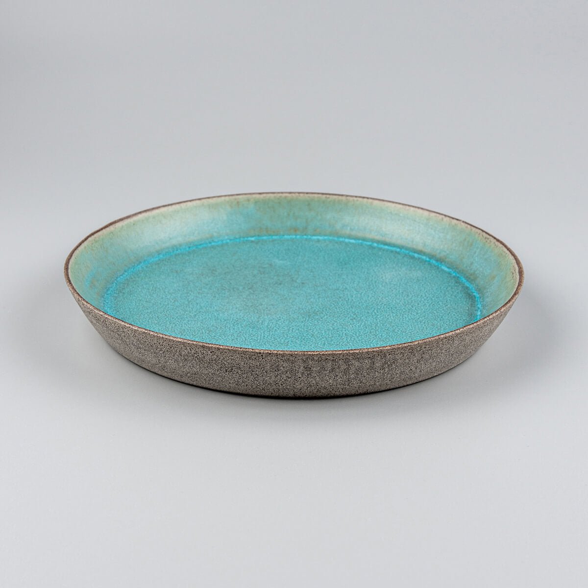 Detail of beveled edge on luxury ceramic dinnerware piece.