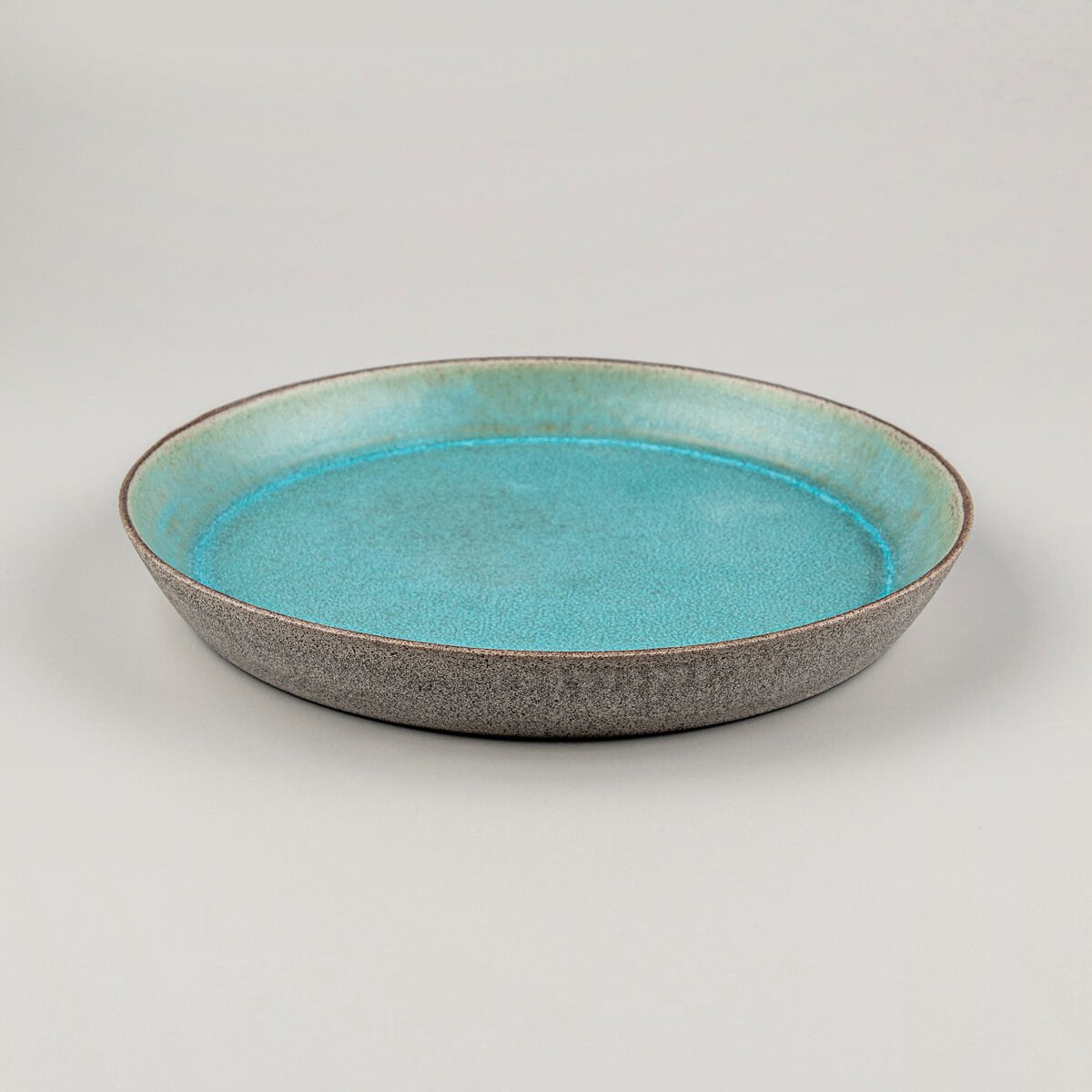 Detail of beveled edge on luxury ceramic dinnerware piece.