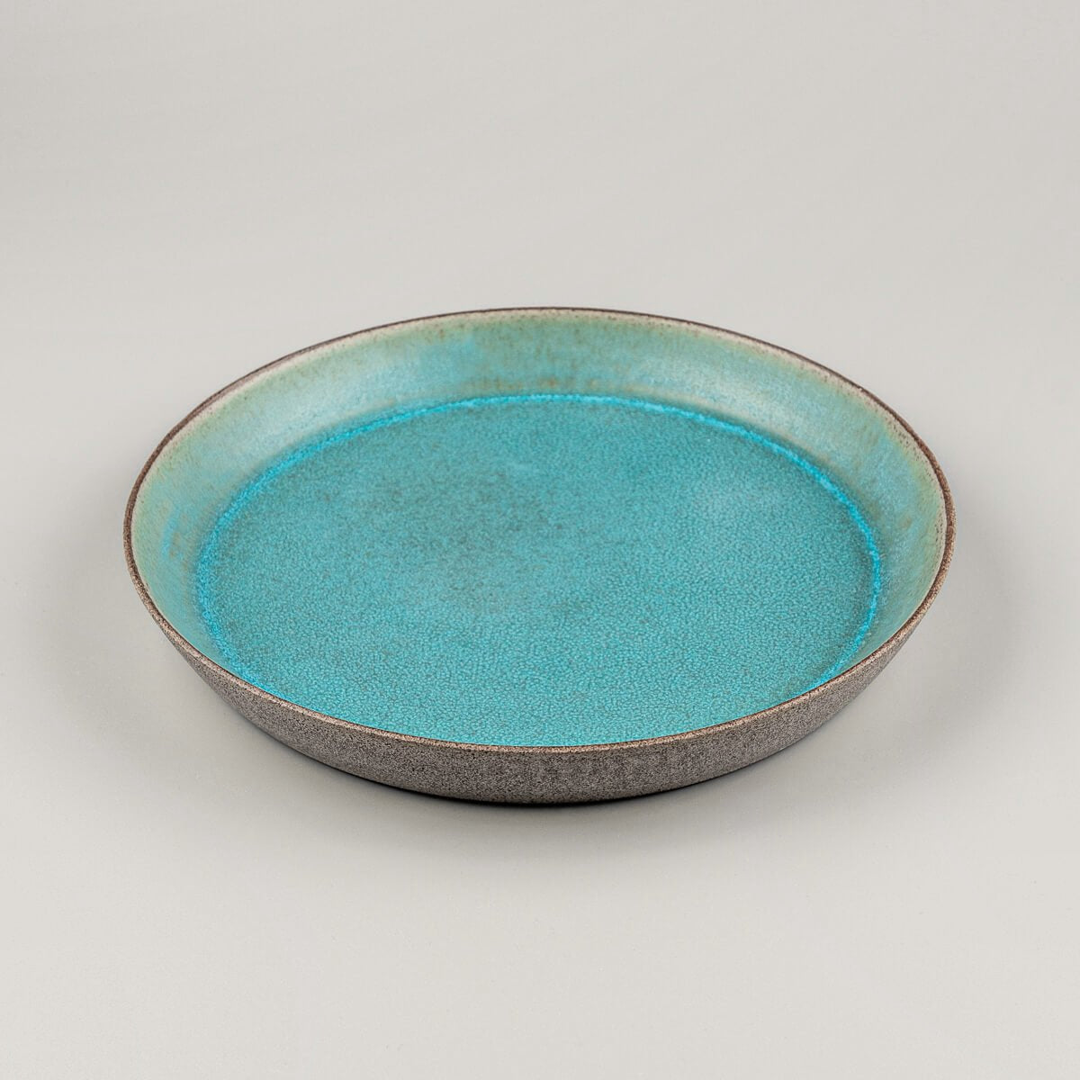 Top-down view showcasing matte turquoise finish of artisanal ceramic plate.