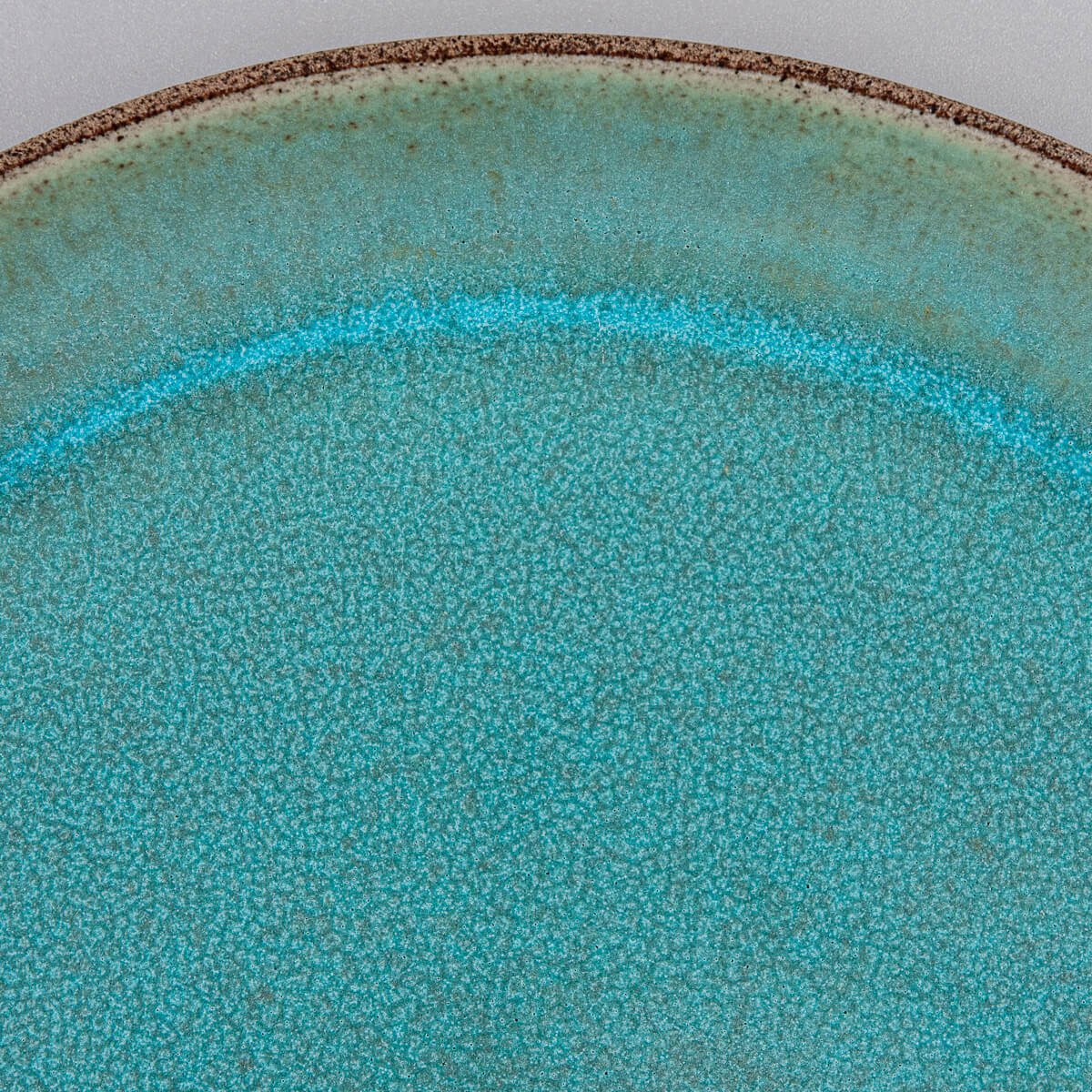Artistic detail of custom handmade ceramic plate for restaurant presentation.