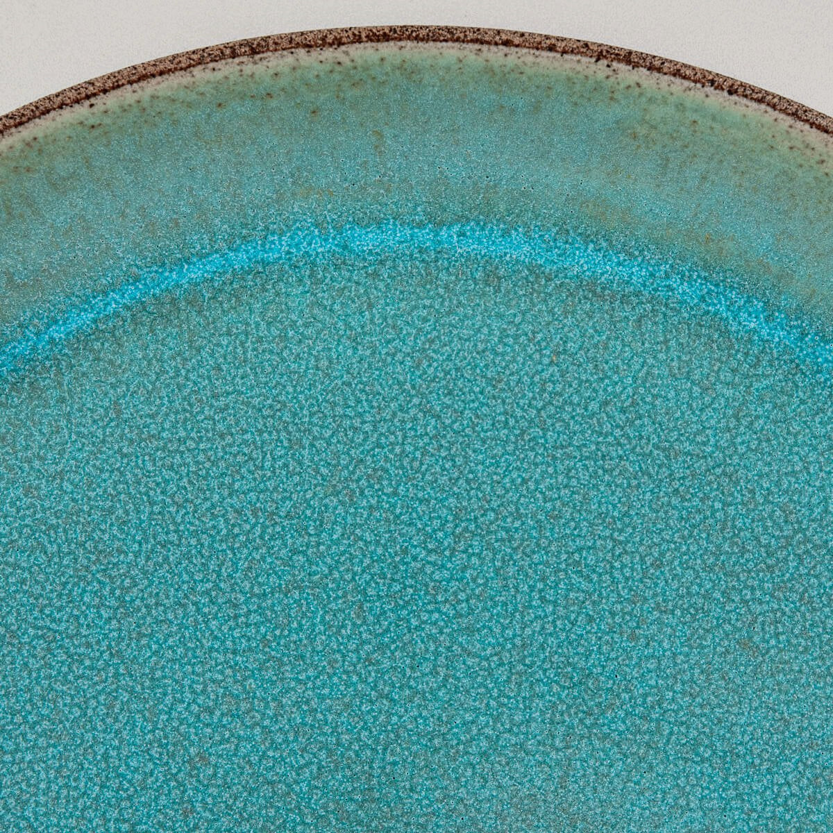Artistic detail of custom handmade ceramic plate for restaurant presentation.