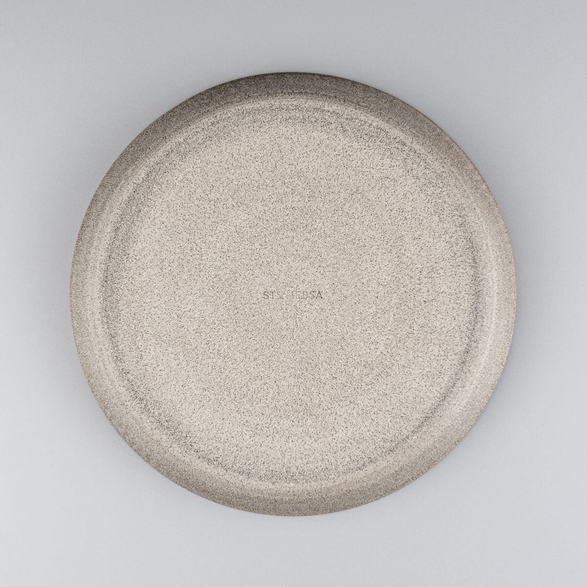 Back view showing unglazed dark stoneware base of artisan-crafted plate.