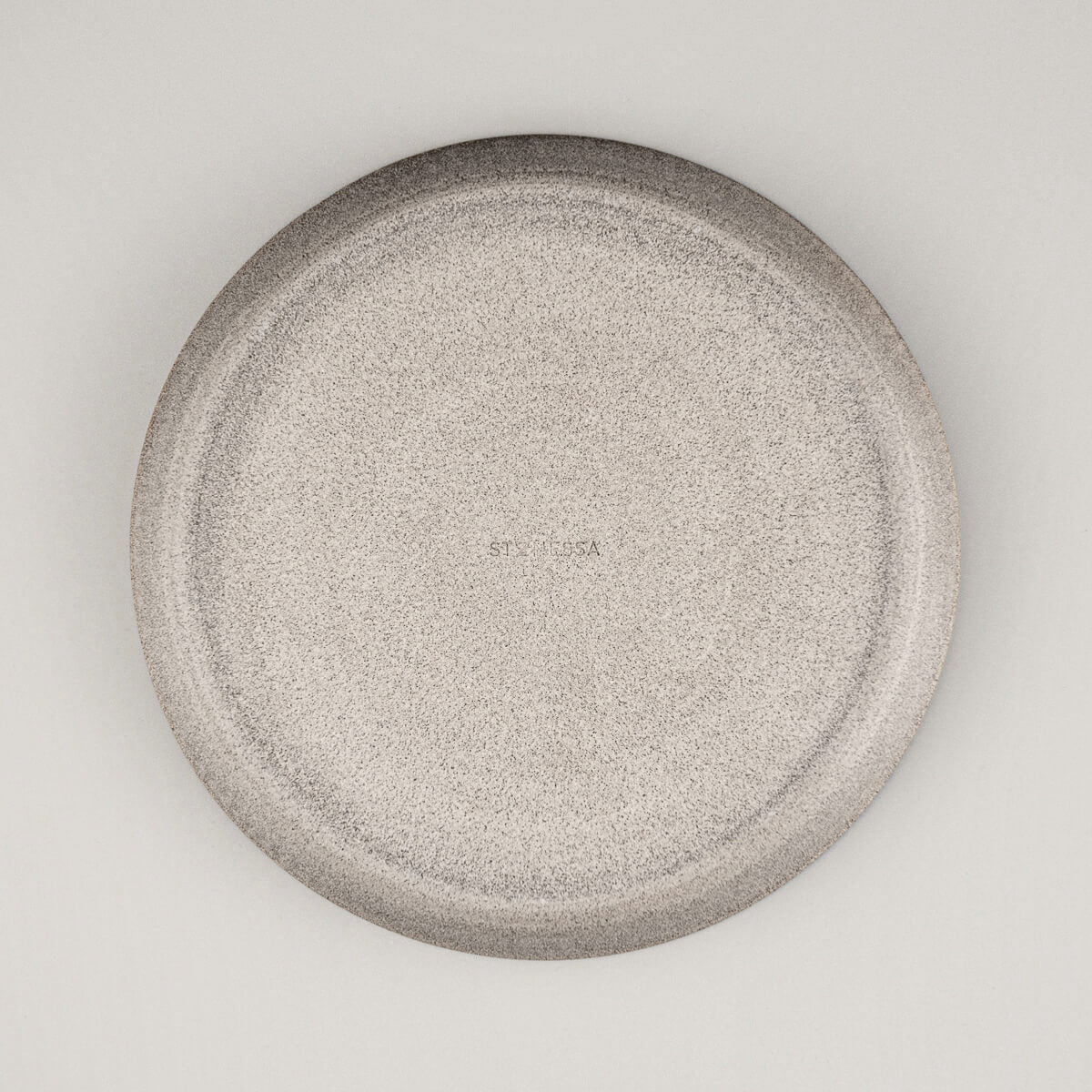 Back view showing unglazed dark stoneware base of artisan-crafted plate.