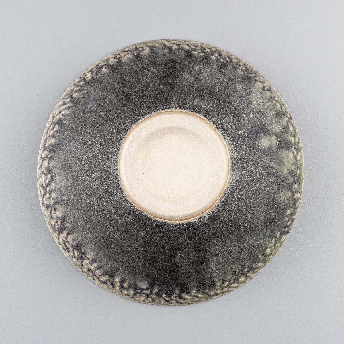 Bottom base detail of ceramic bowl showing handcrafted artisan ceramic finish.