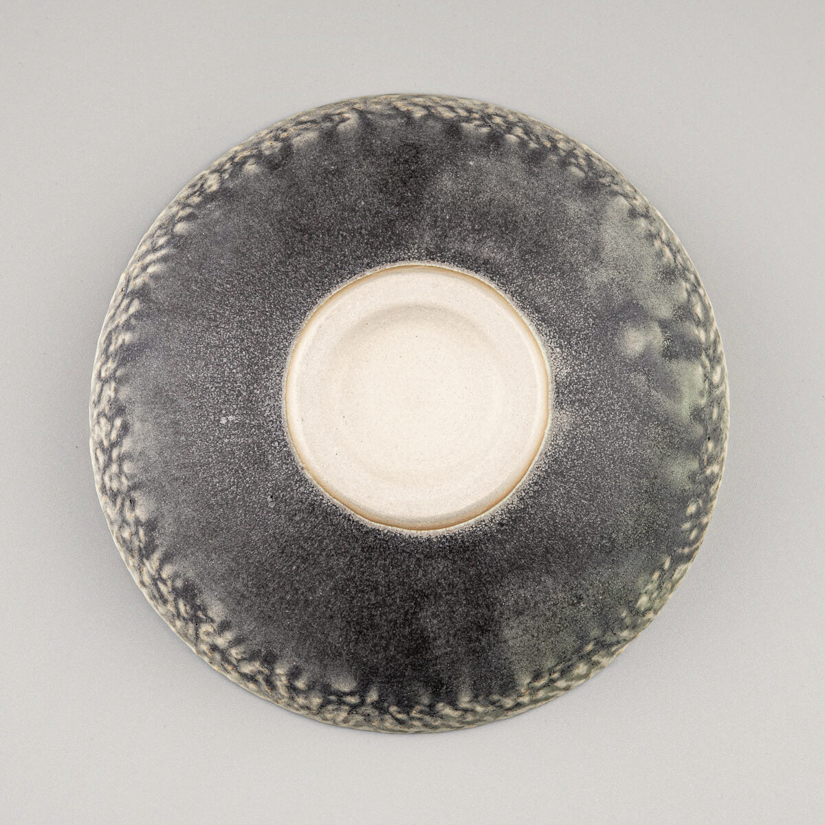 Bottom base detail of ceramic bowl showing handcrafted artisan ceramic finish.
