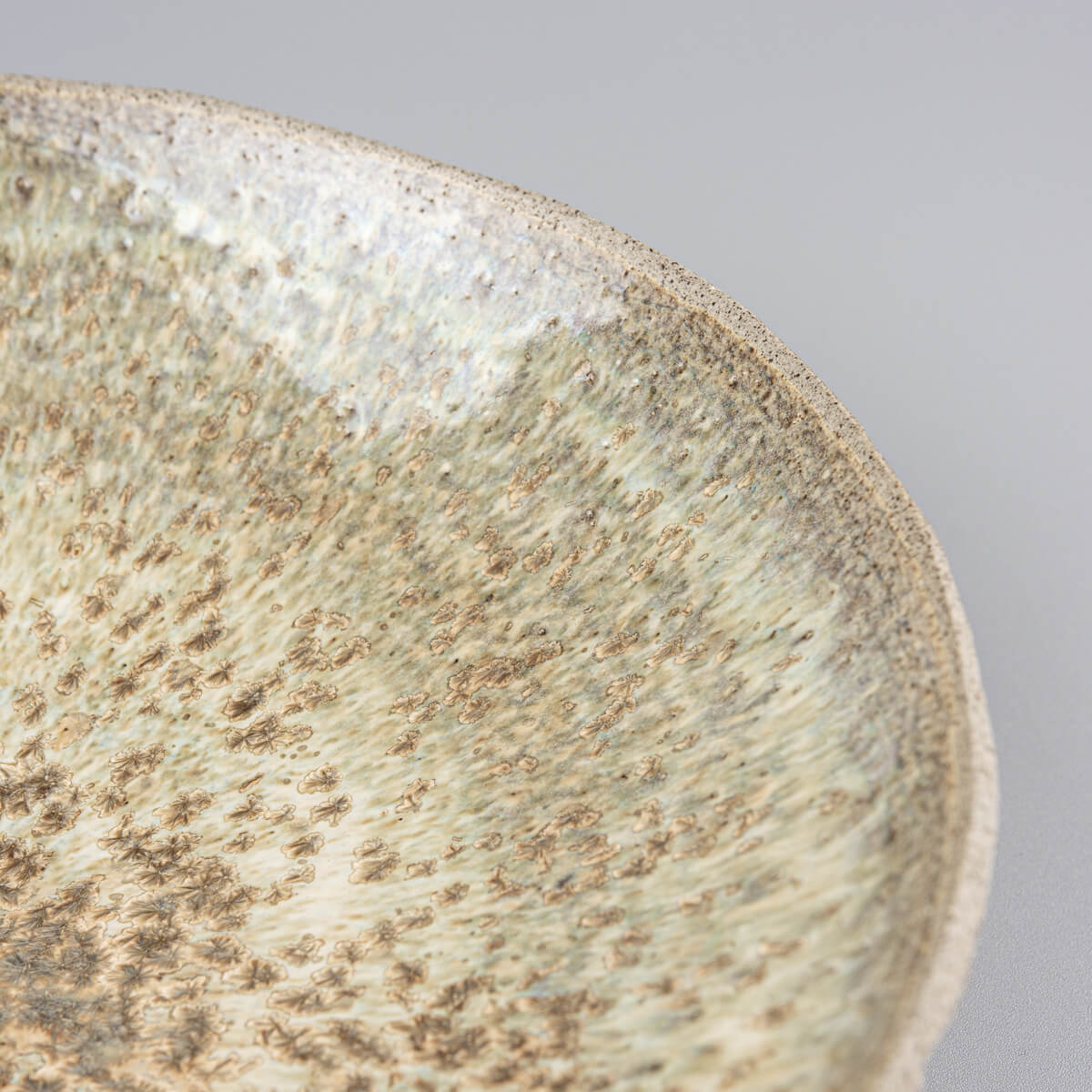 Close-up of speckled glossy glaze on interior, perfect for high-end culinary presentations.