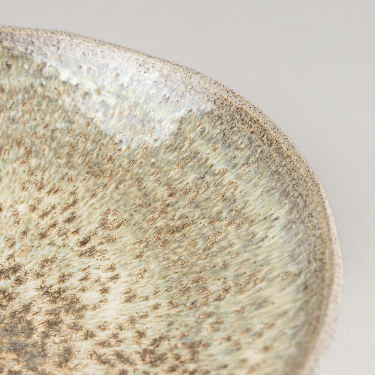Close-up of speckled glossy glaze on interior, perfect for high-end culinary presentations.