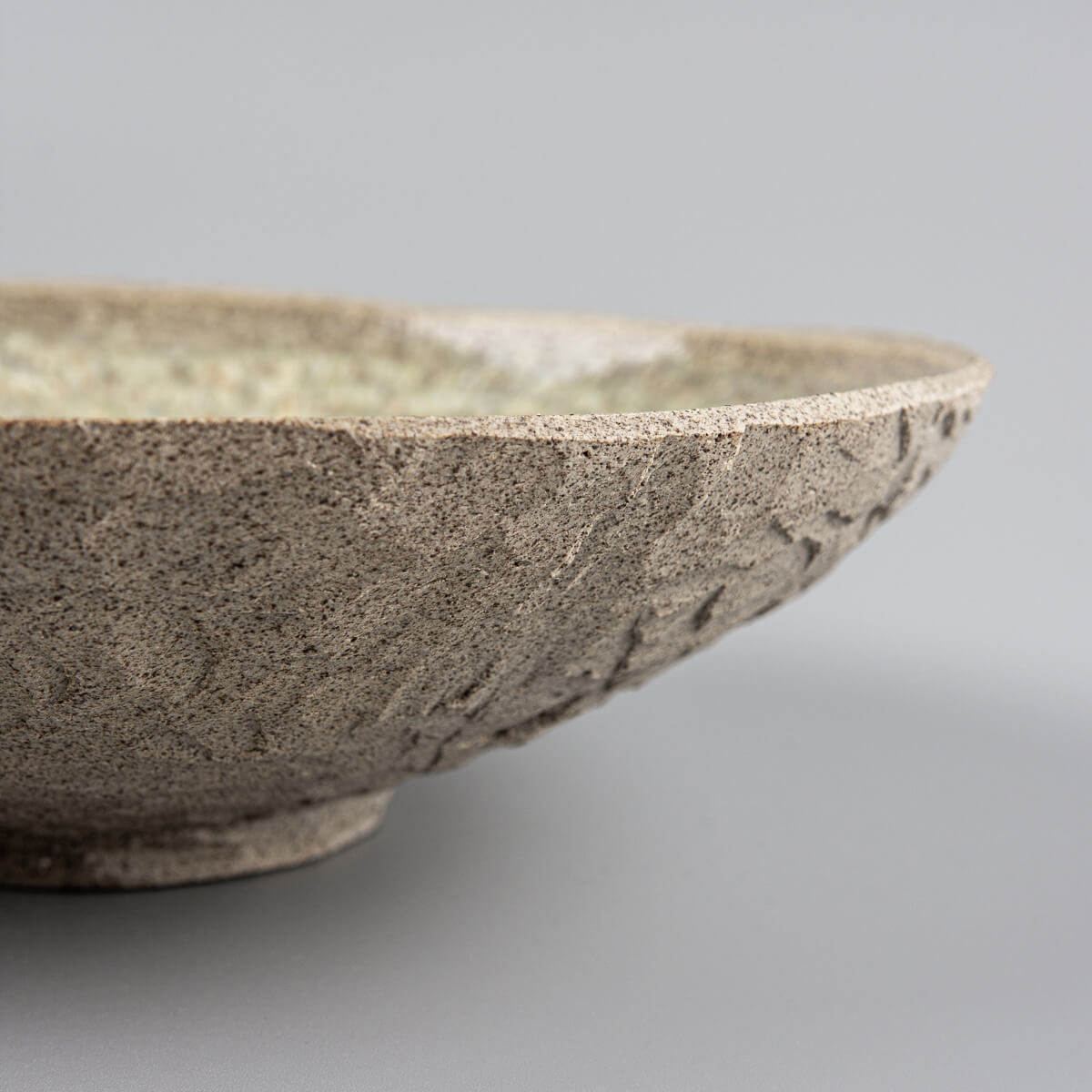 Detailed view of inner glaze pattern on handmade ceramic stoneware dinner plate.