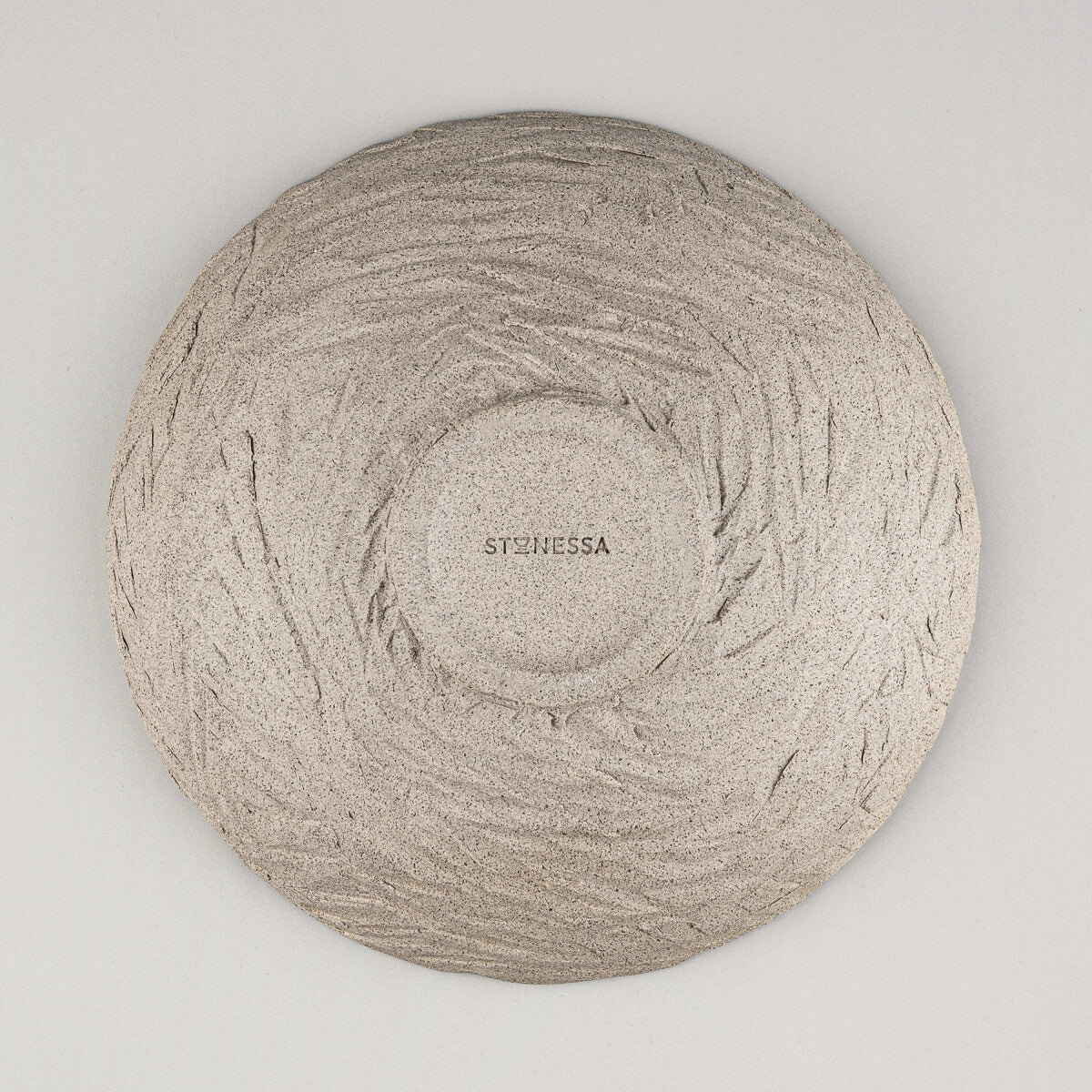 Perspective showing plate's rim and contrast between glazed and raw surfaces.