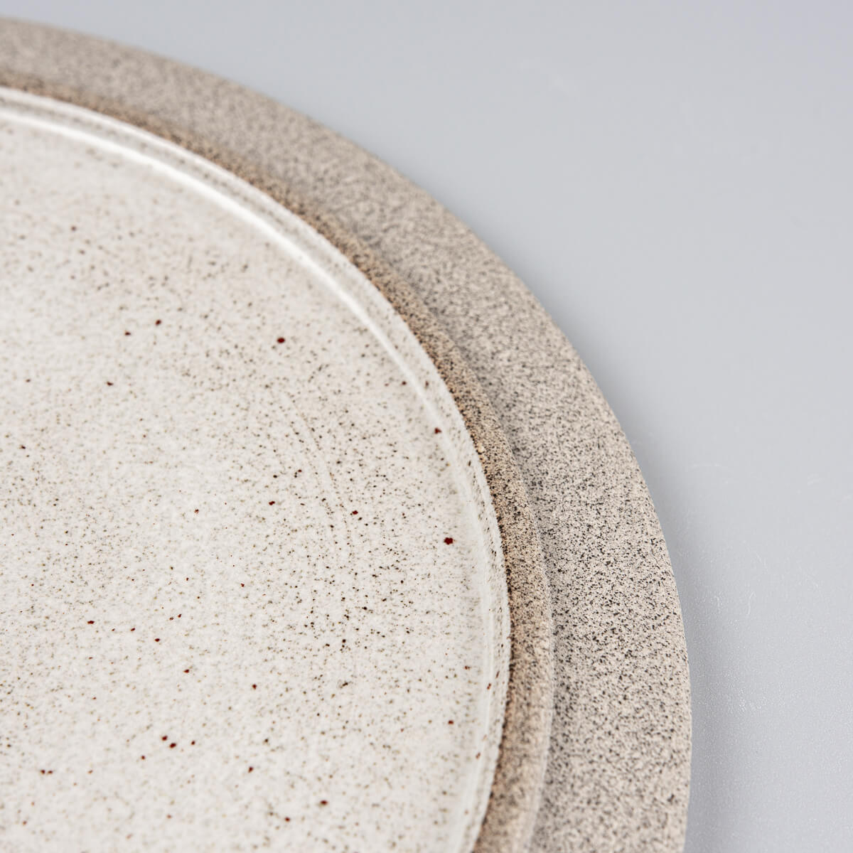 Close-up of the subtle rim and glaze transition on artisanal stoneware plate.