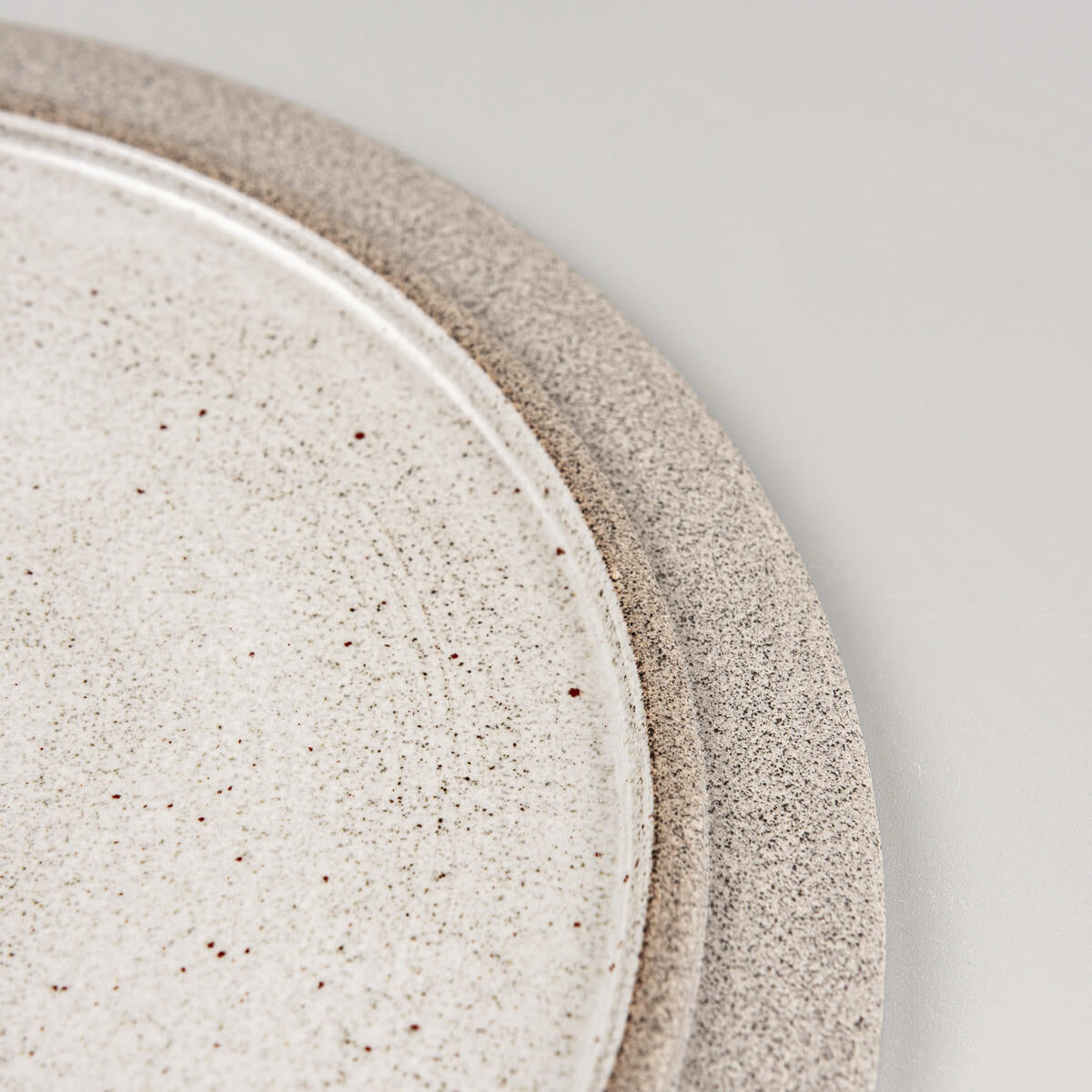 Close-up of the subtle rim and glaze transition on artisanal stoneware plate.