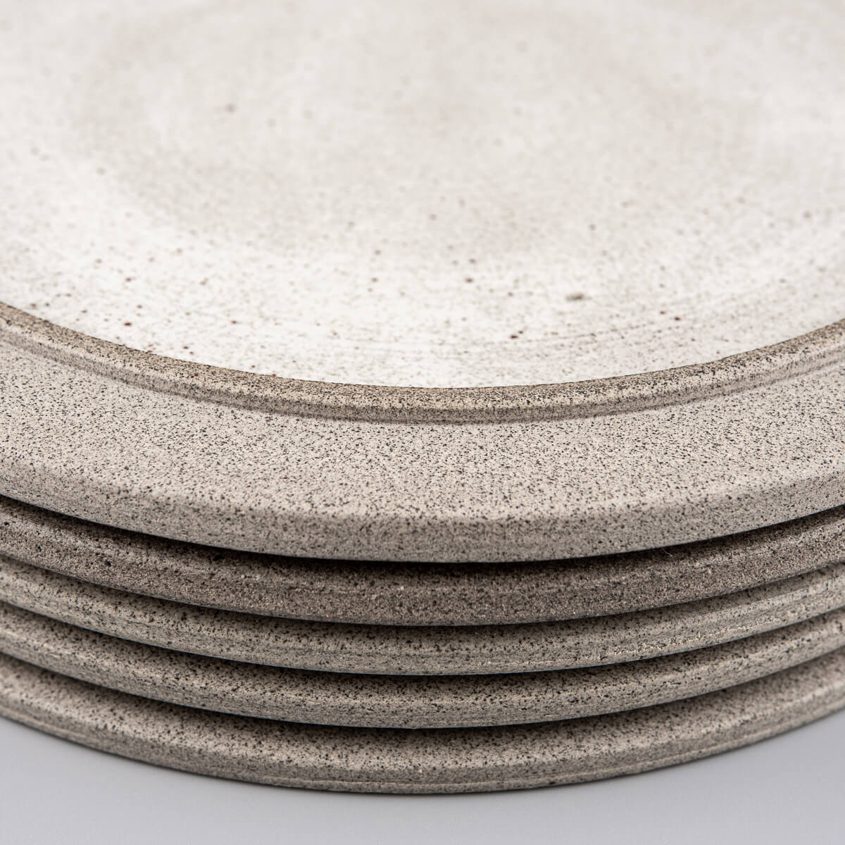 Artisanal ceramic plates displayed in a refined tableware collection.