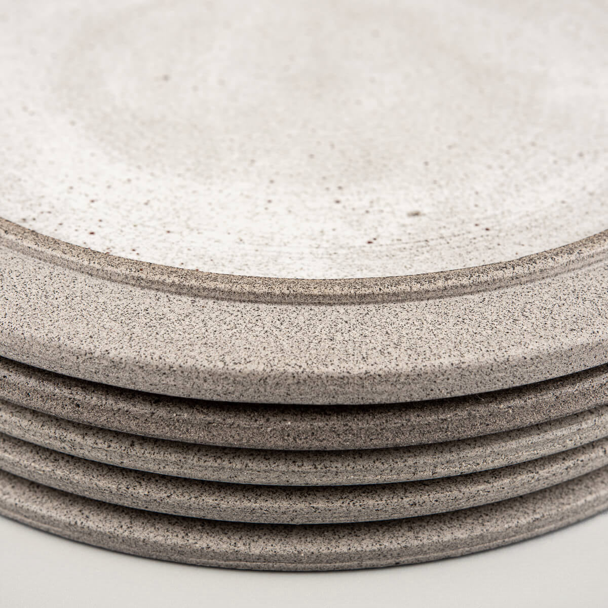 Artisanal ceramic plates displayed in a refined tableware collection.