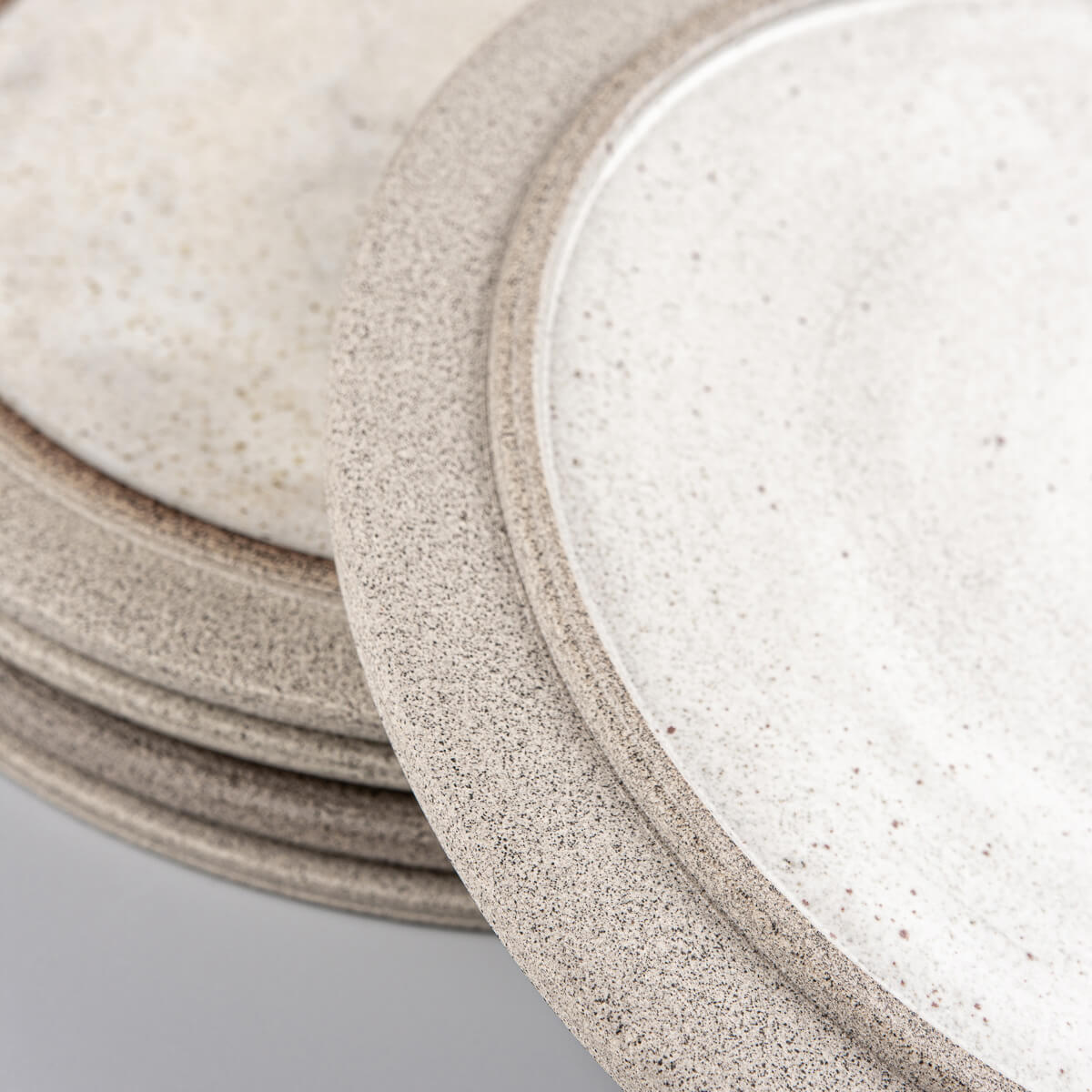 Home and restaurant stoneware plate set in white and earthy gray for sophisticated dining.