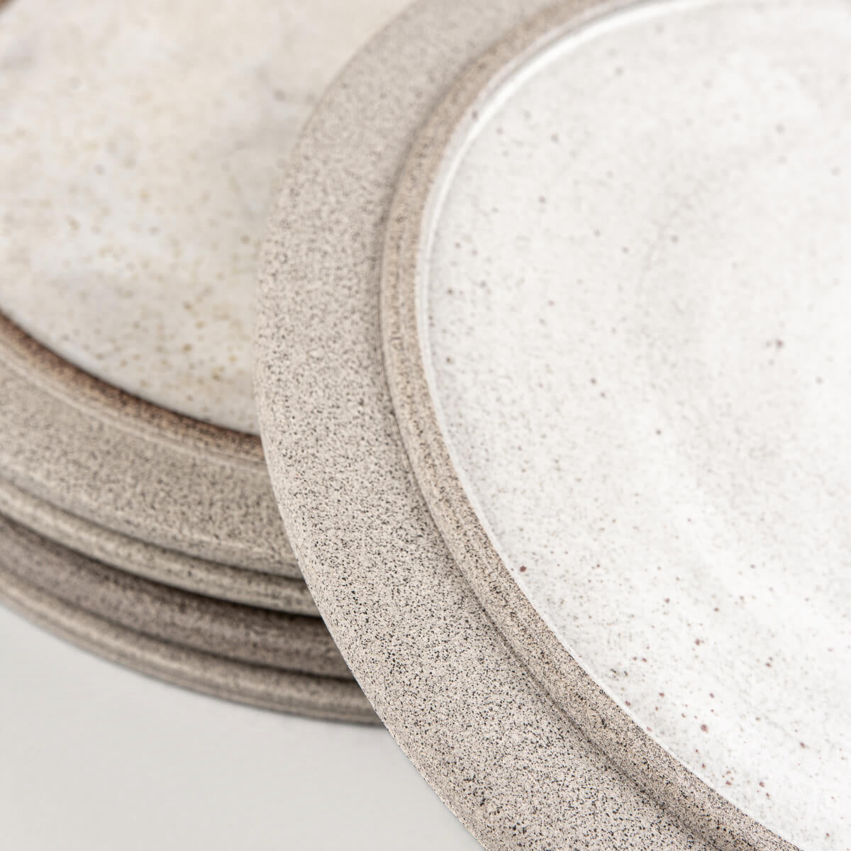 Home and restaurant stoneware plate set in white and earthy gray for sophisticated dining.