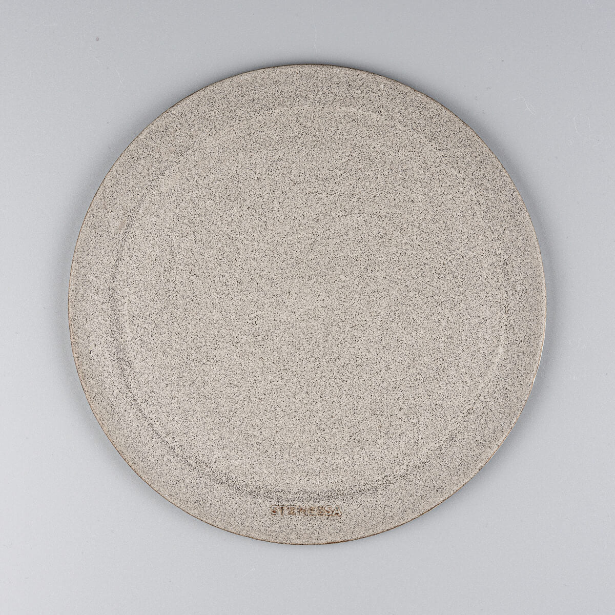 Underside of handmade ceramic serving plate showing natural clay finish.