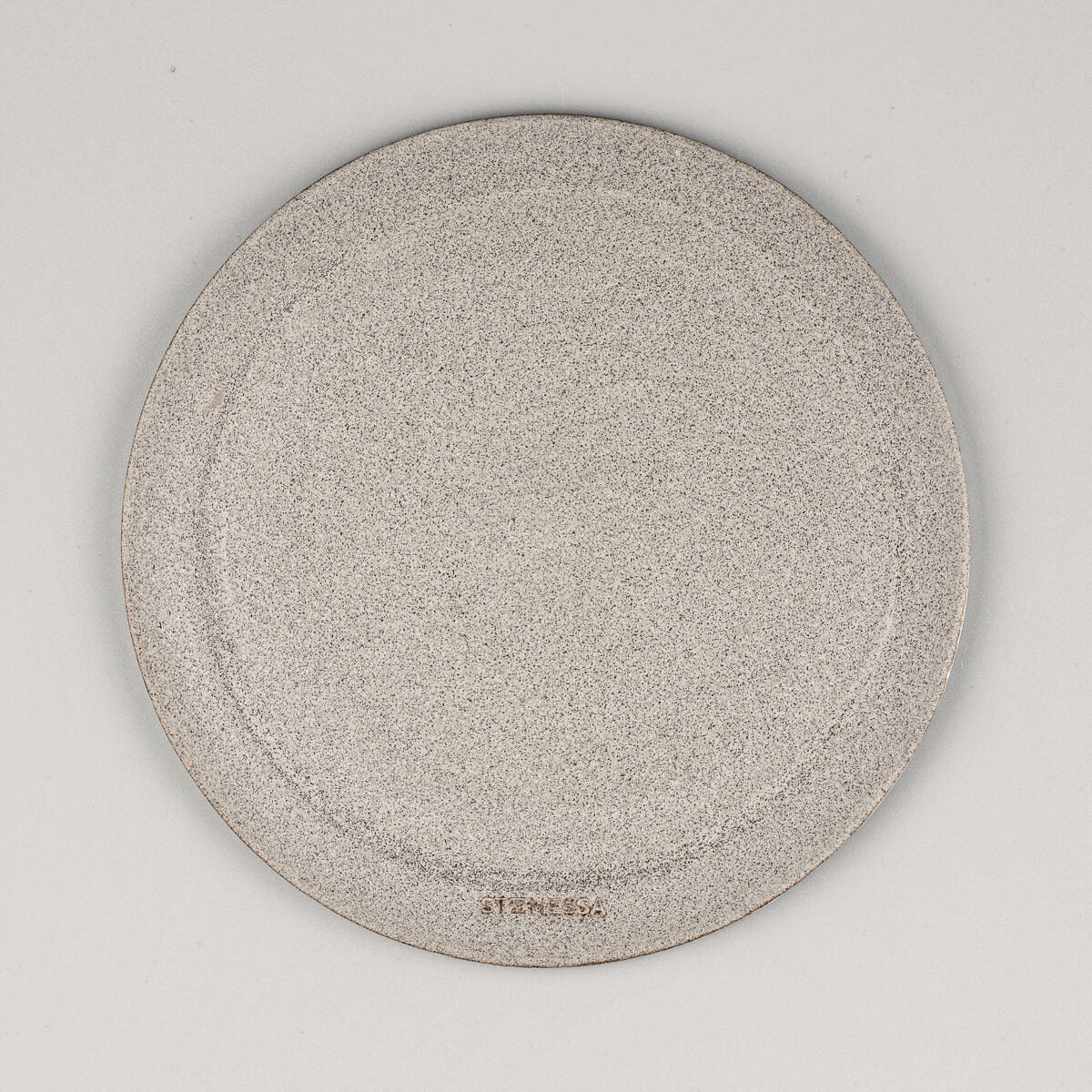 Underside of handmade ceramic serving plate showing natural clay finish.