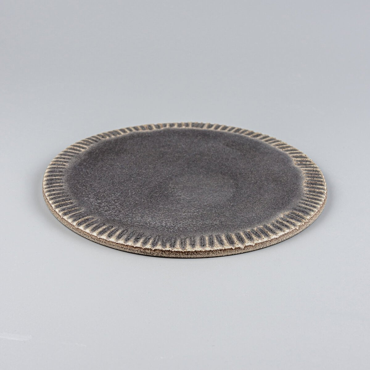 Artisanal dark stoneware dessert plate with flat surface for restaurants and boutique hotels.