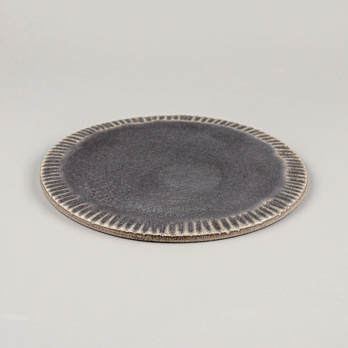 Artisanal dark stoneware dessert plate with flat surface for restaurants and boutique hotels.