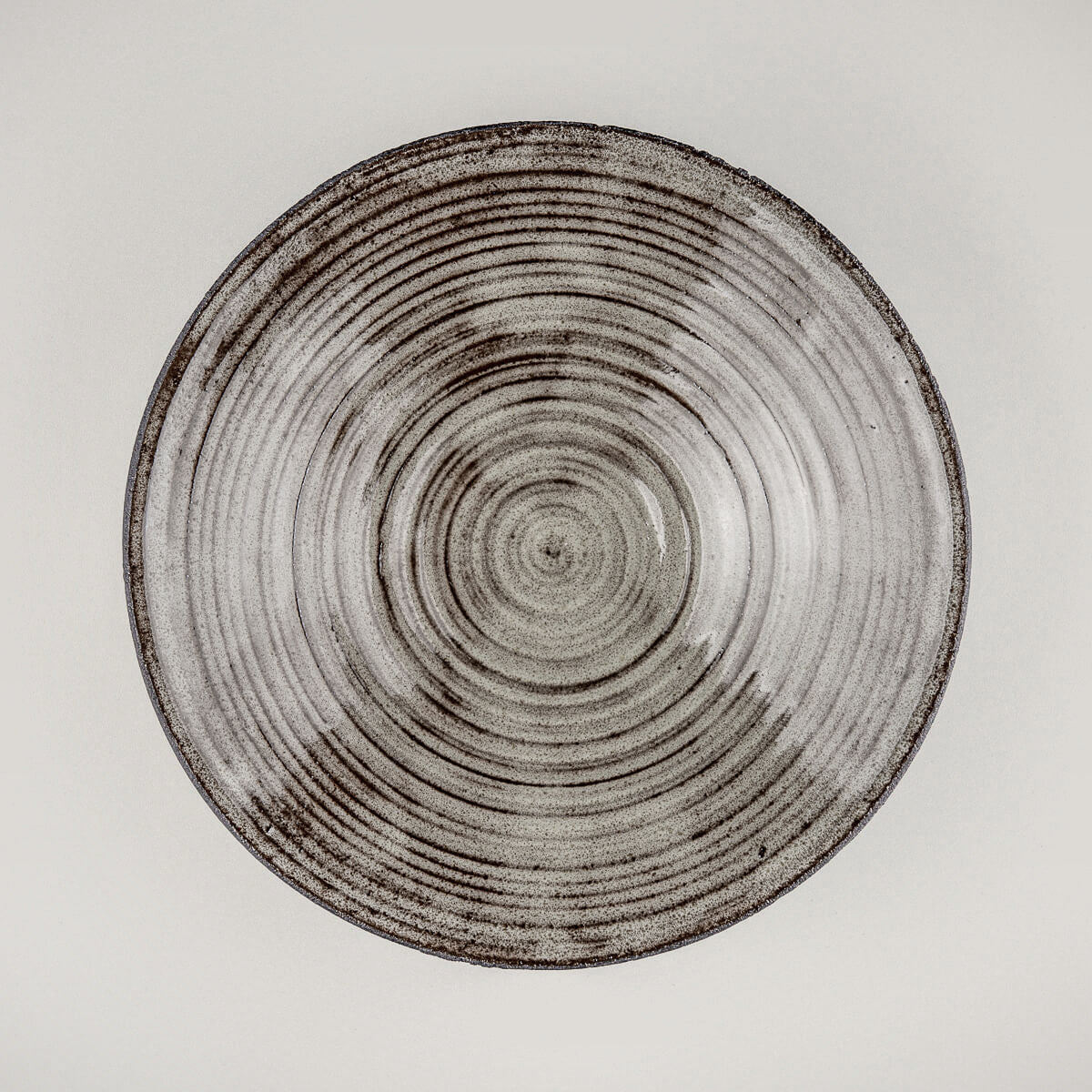 Elegant stoneware dinner plate with glossy gray glazed interior and unglazed black clay exterior for luxury fine dining.