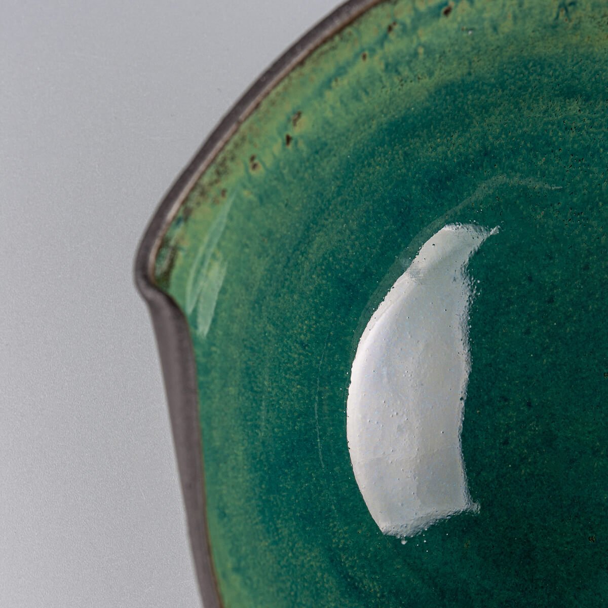 Close-up of bowl’s rim highlighting hand-formed indentations and organic shape.