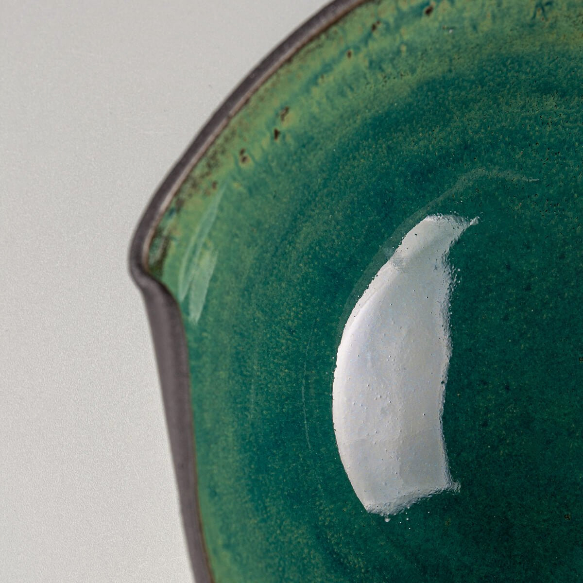 Close-up of bowl’s rim highlighting hand-formed indentations and organic shape.