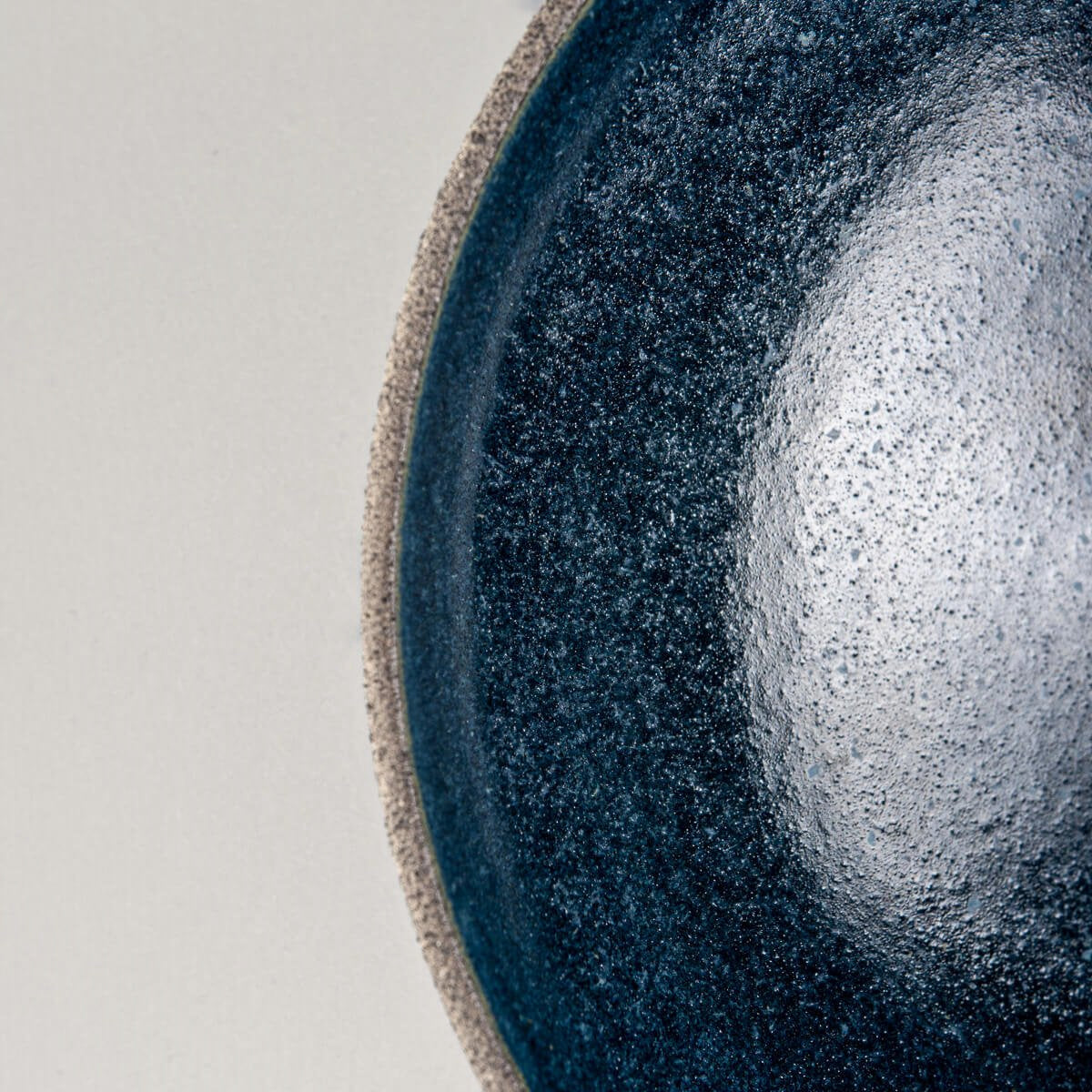 Detail of rim showing transition between raw exterior and glazed ceramic interior.