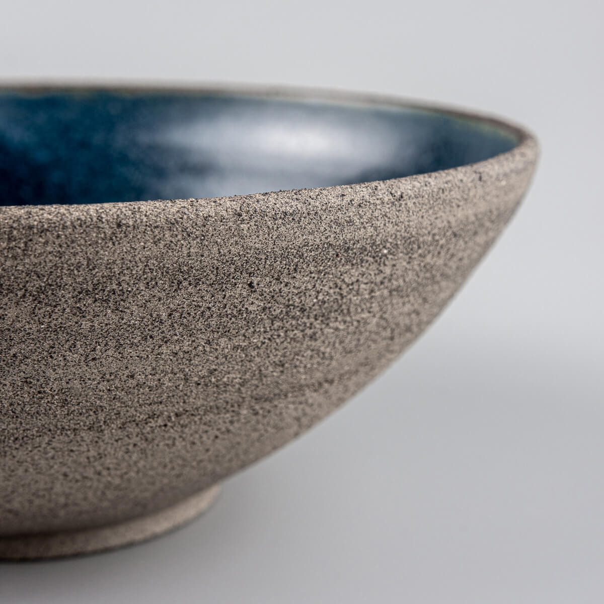 Side profile emphasizing balance and shape of handcrafted stoneware bowl.