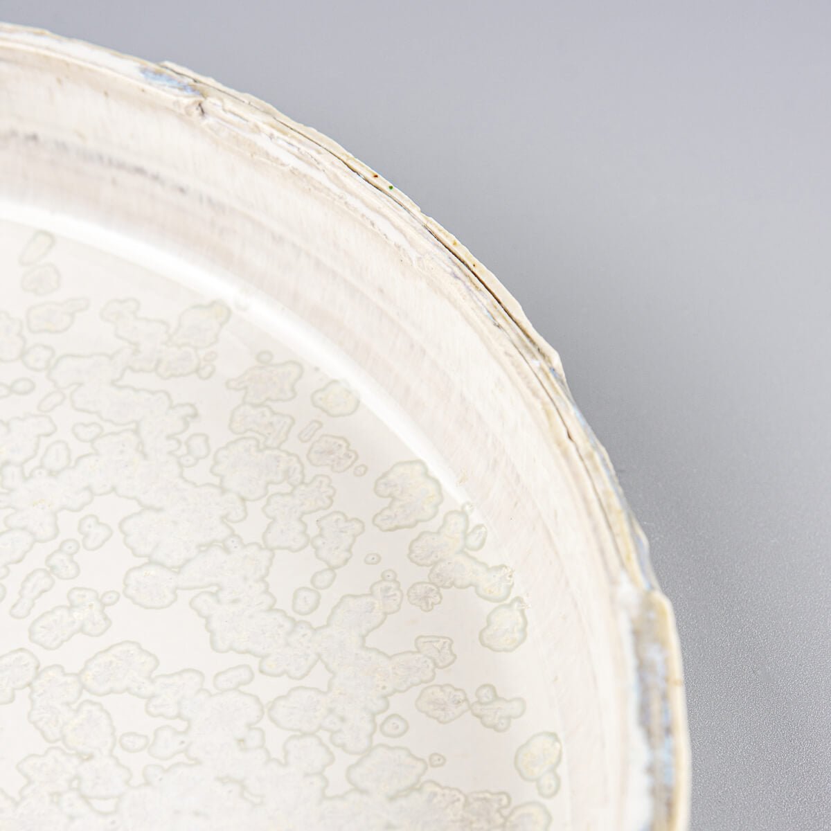 Handcrafted, unique ceramic plate with refined carving and harmonious gray glaze tones.