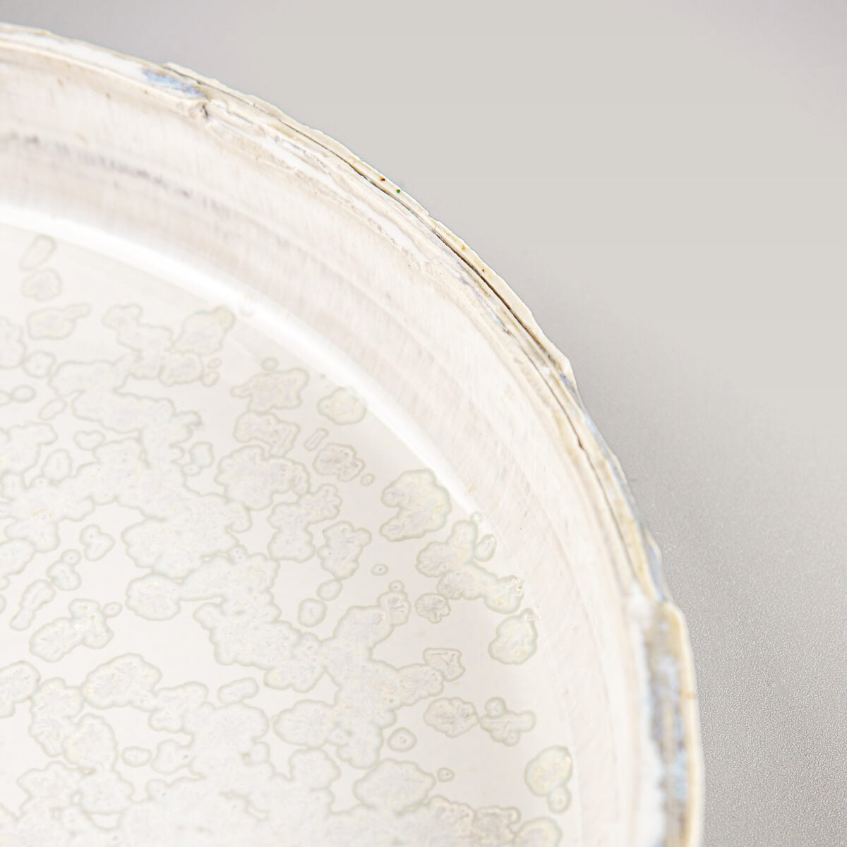 Handcrafted, unique ceramic plate with refined carving and harmonious gray glaze tones.