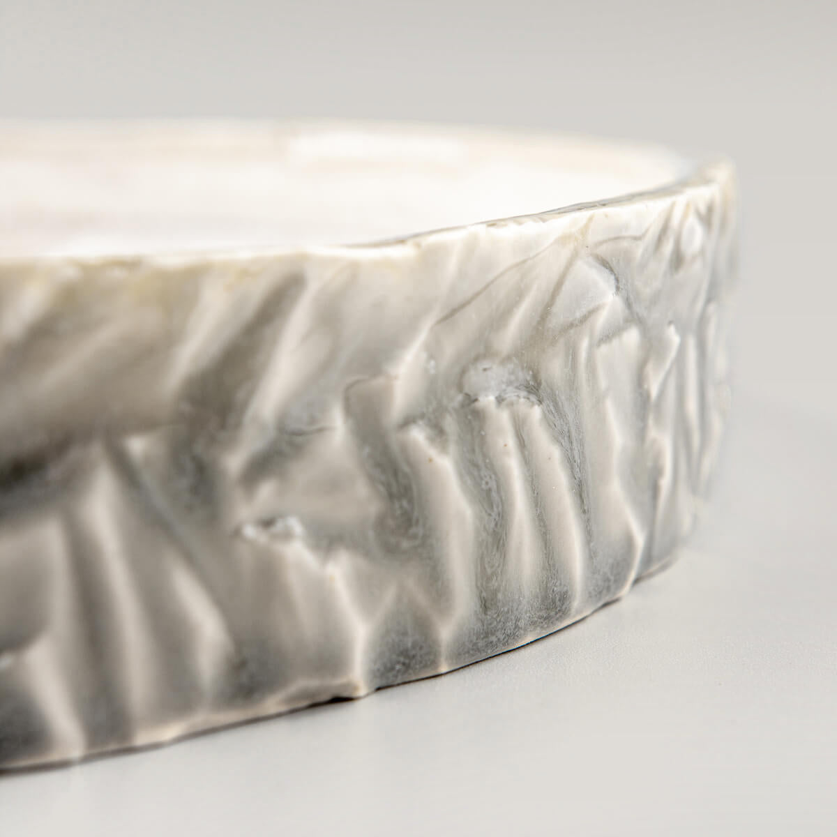 Close-up of plate’s rim with subtle chipping for organic artisan finish.