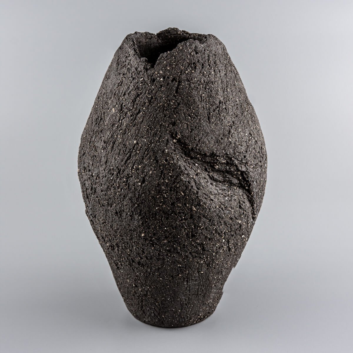 Luxury pottery vase handmade with dark stoneware clay for interior design and collectible pottery.