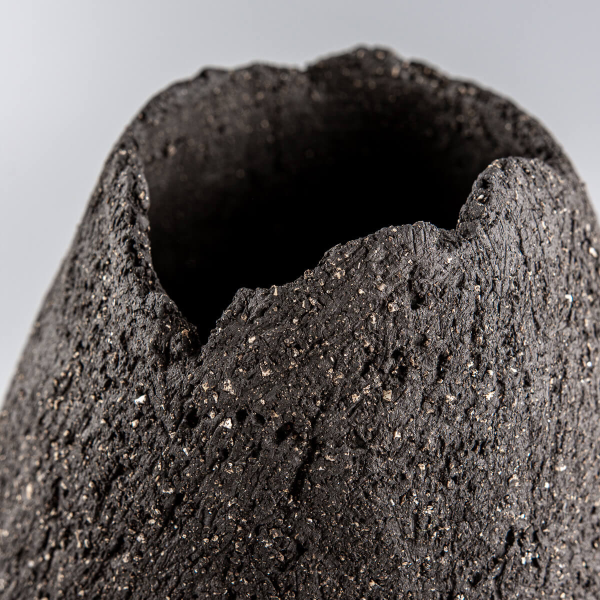 Unglazed stoneware pottery vase handmade with a diamond shape for home and boutique hotel decor.