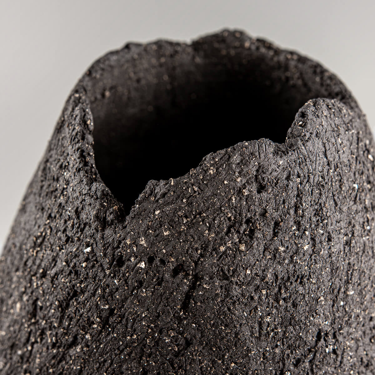 Unglazed stoneware pottery vase handmade with a diamond shape for home and boutique hotel decor.