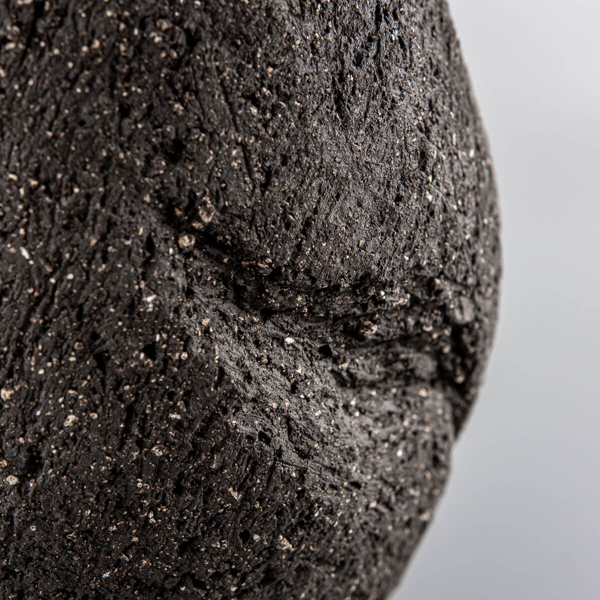 Textured dark clay pottery vase handmade with natural indentation detail for a housewarming gift.