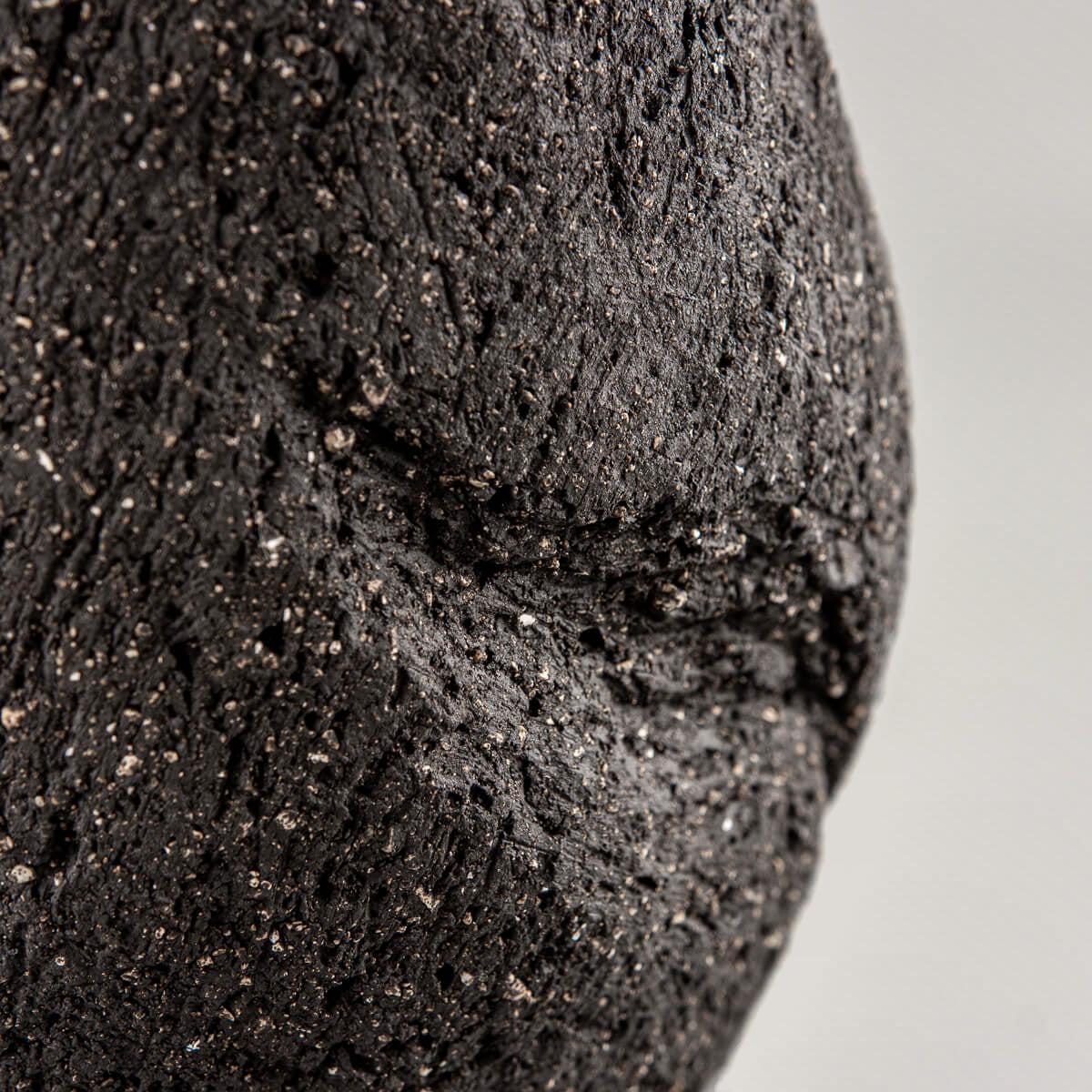 Textured dark clay pottery vase handmade with natural indentation detail for a housewarming gift.
