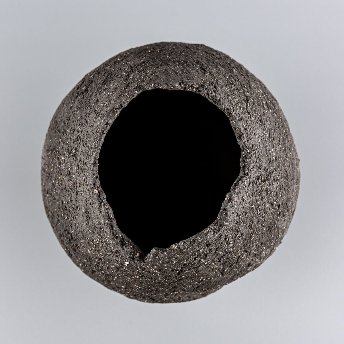 Handmade pottery vase with a narrow base and textured stoneware surface for a wedding gift.