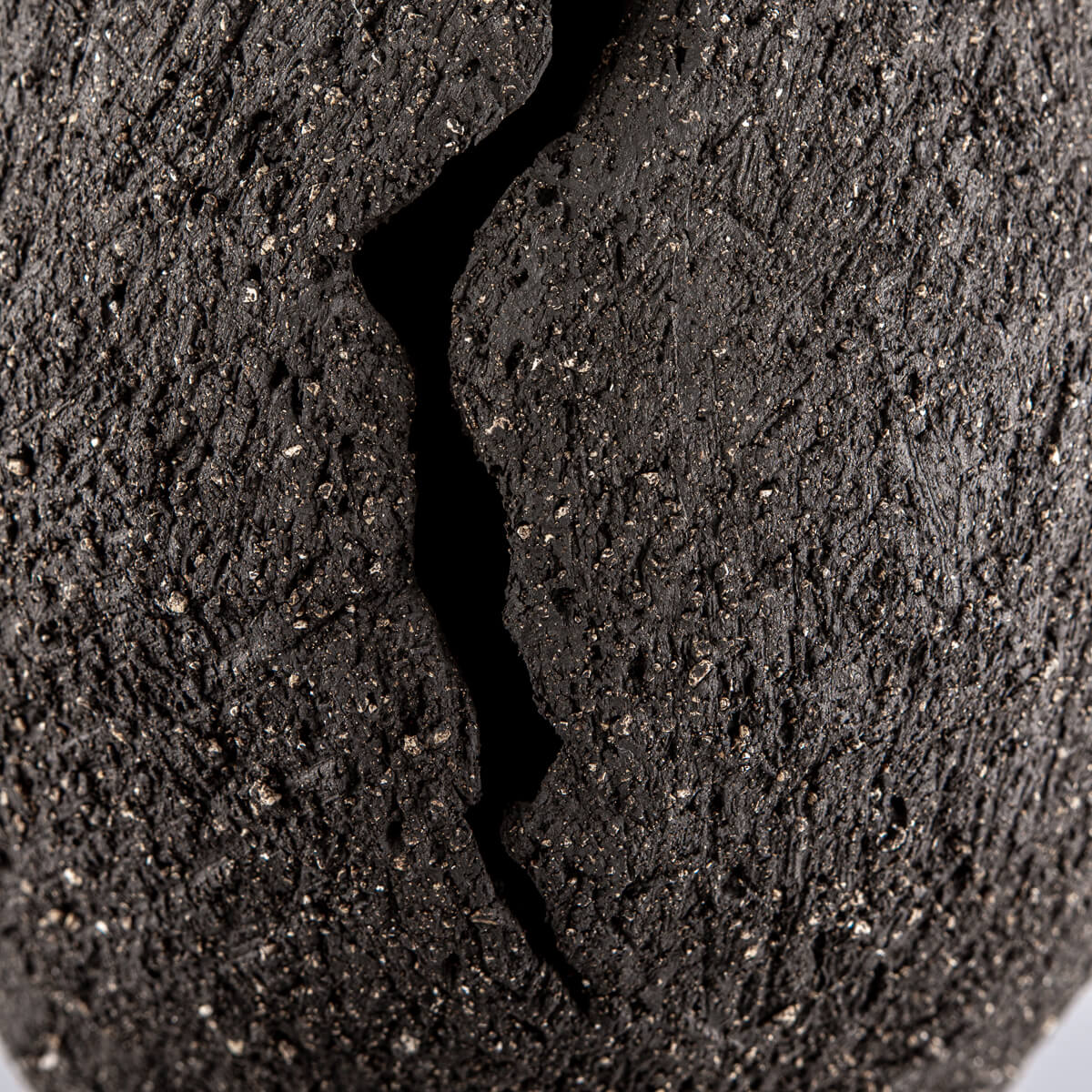 Organic handmade decor piece crafted from textured stoneware clay for exclusive spaces.