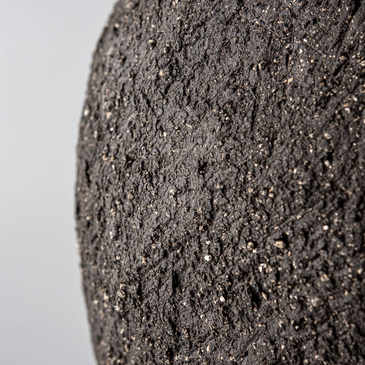 Artistic stoneware vase with raw dark clay finish, ideal for private collectors and design lovers.