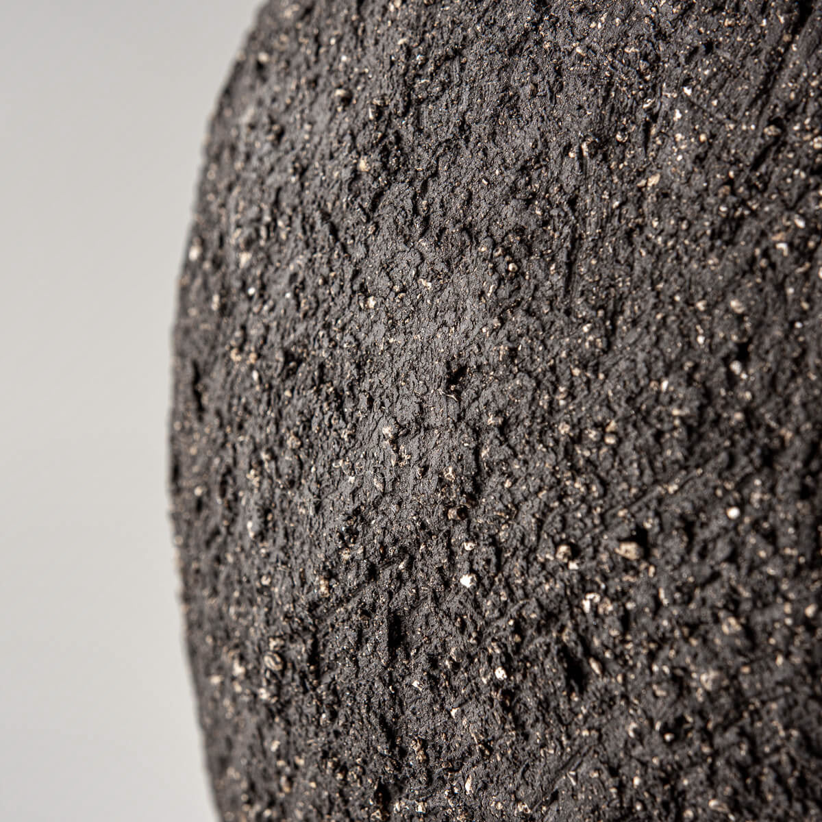 Artistic stoneware vase with raw dark clay finish, ideal for private collectors and design lovers.