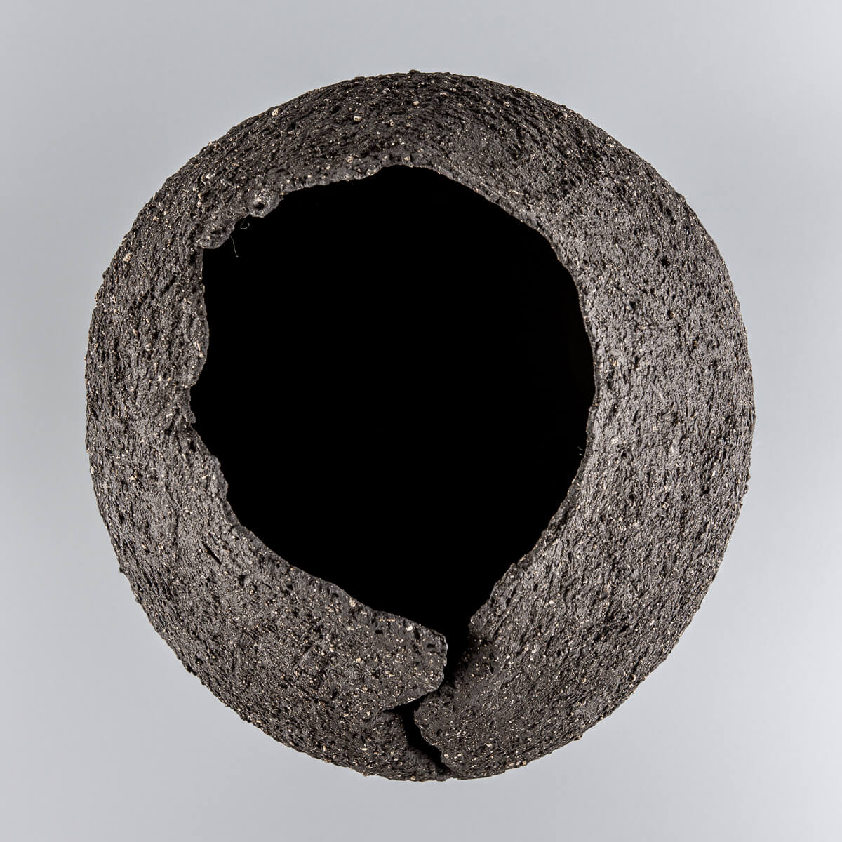 Collectible pottery vase with volcanic-inspired texture for boutique hotel and home decor.