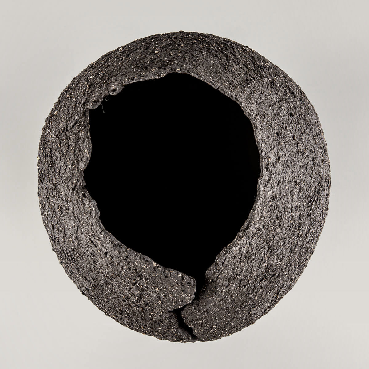 Collectible pottery vase with volcanic-inspired texture for boutique hotel and home decor.