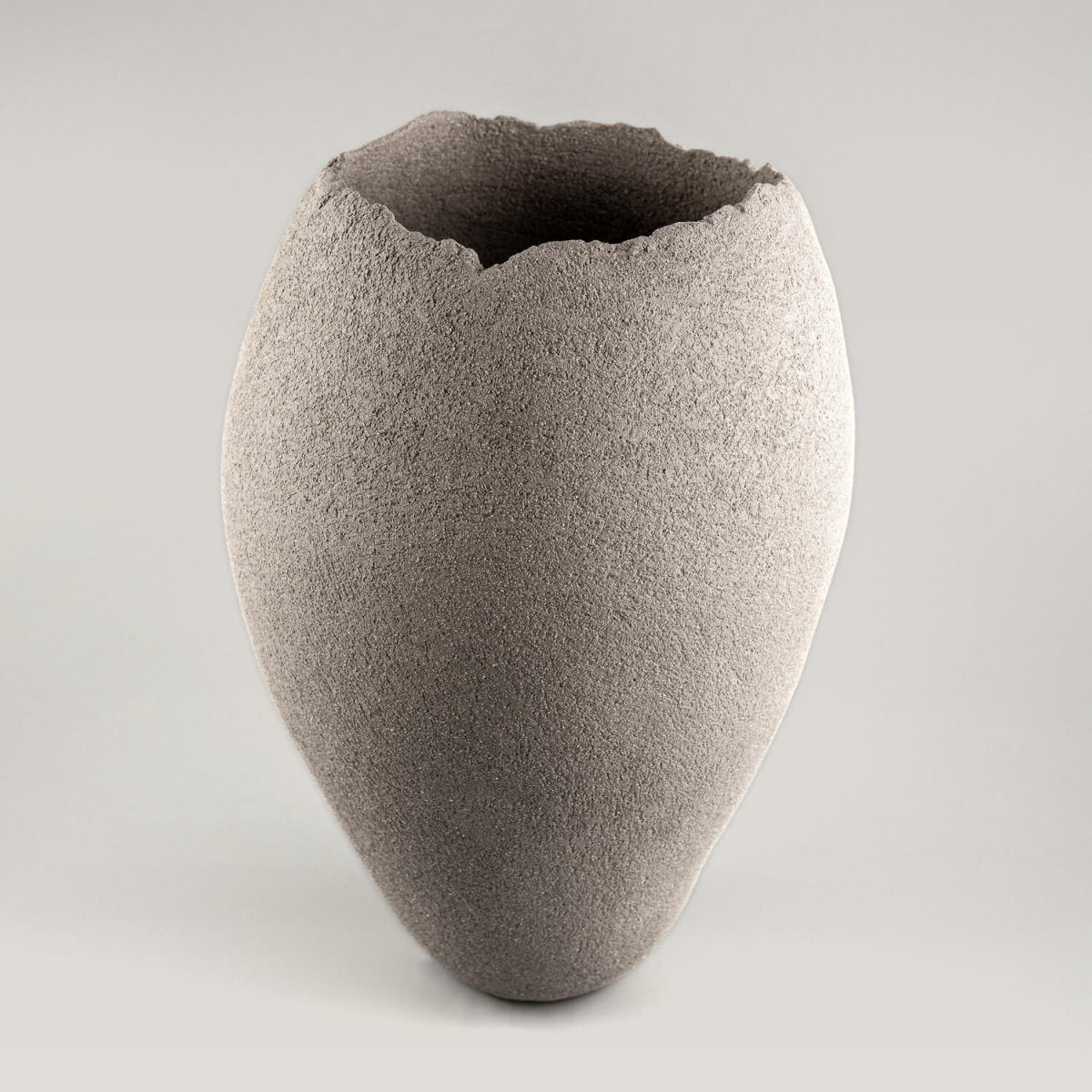 Handmade vases in sculptural gray stoneware clay with a natural textured surface.