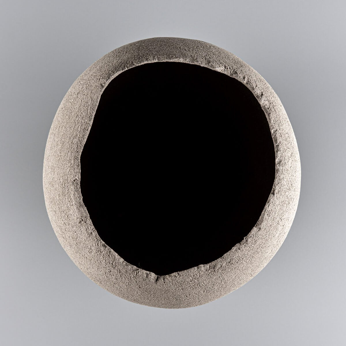Minimalist handmade vases with organic, unglazed clay interior.