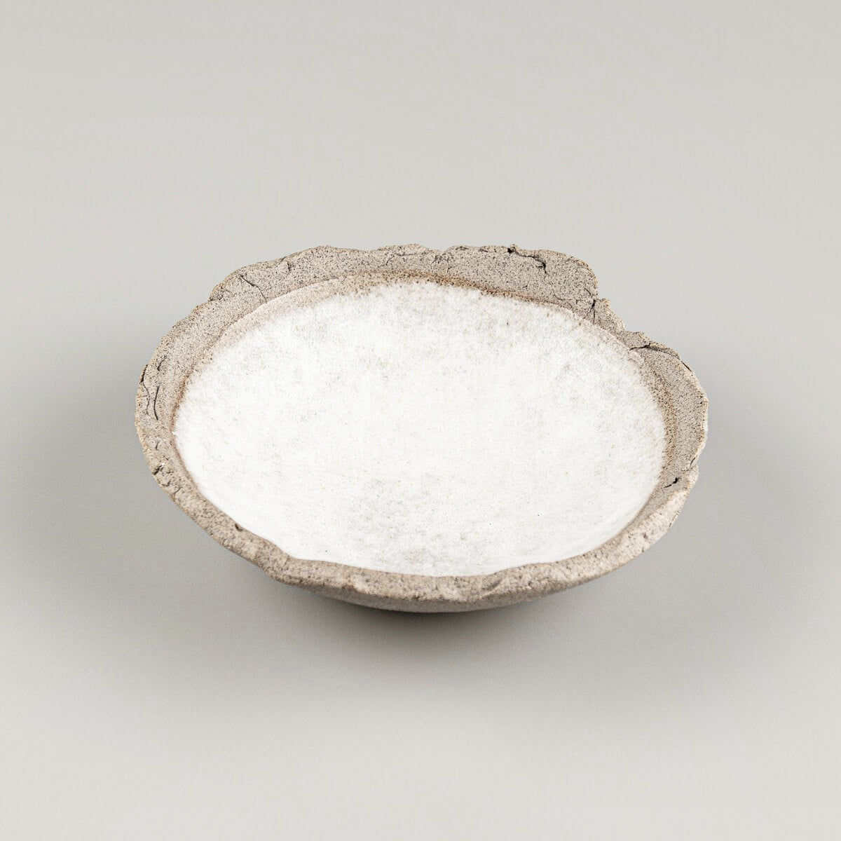 Handcrafted stoneware sushi plate with white matte glazed interior and natural textured clay rim.