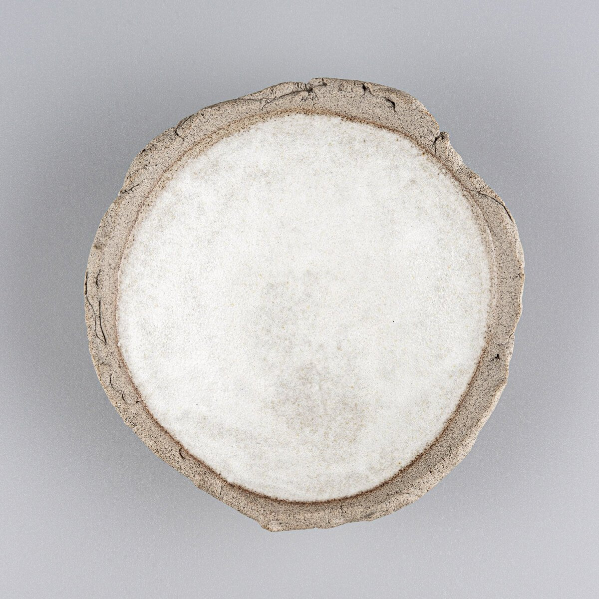 Top view of small oval stoneware sushi plate with smooth glazed center.